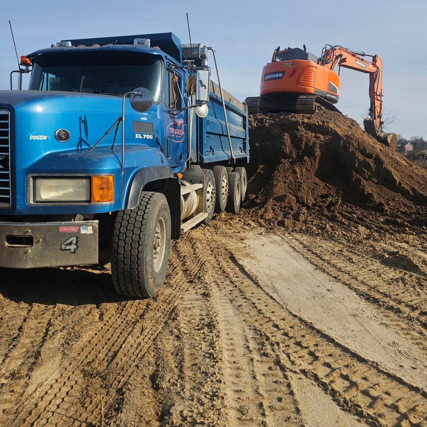 A blue dump truck with the number 4 on it