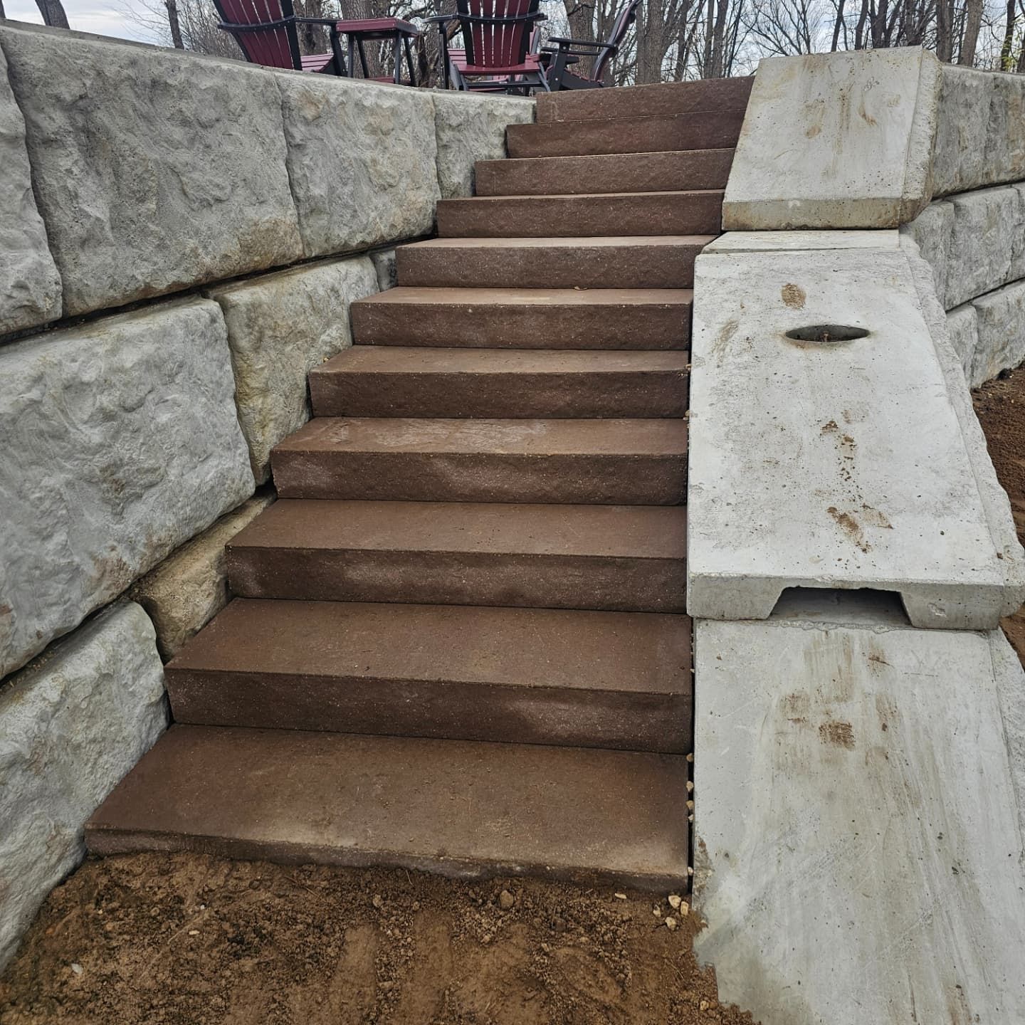 A set of stairs leading up to a stone wall.