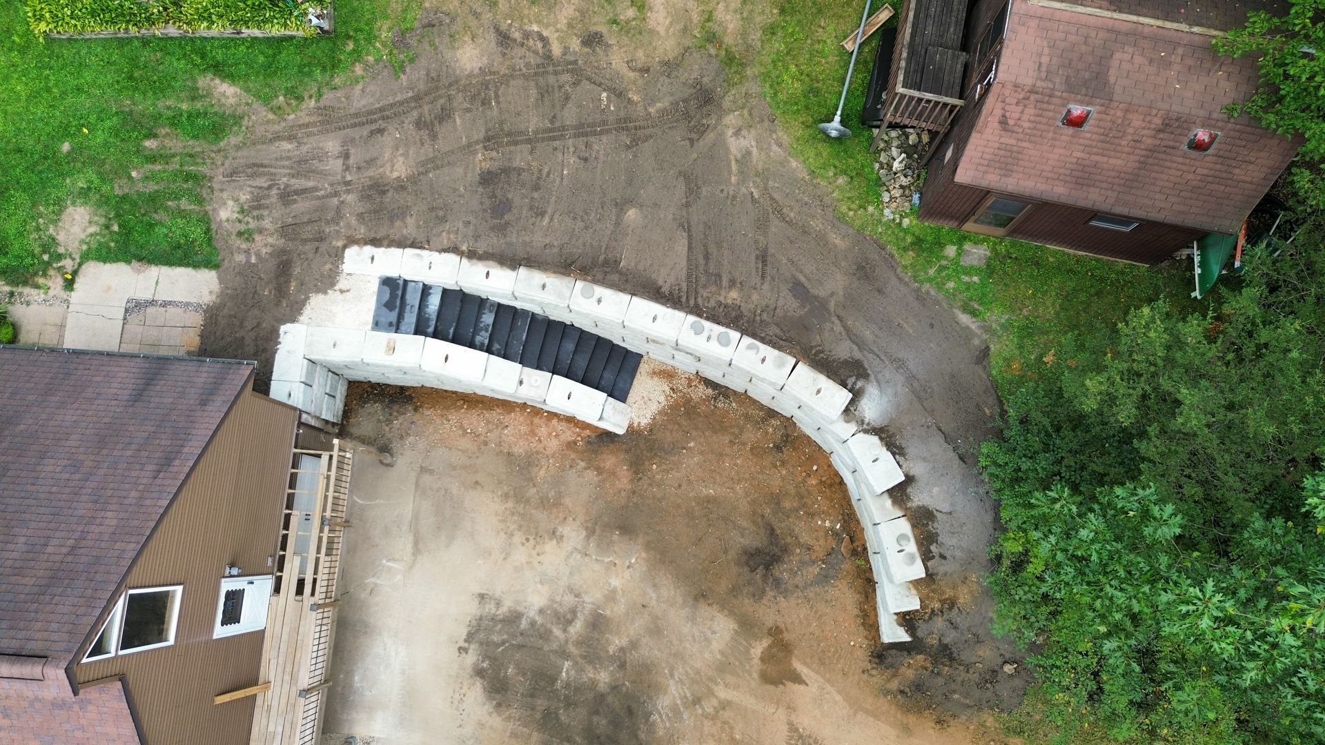 An aerial view of a house and a bridge being built.