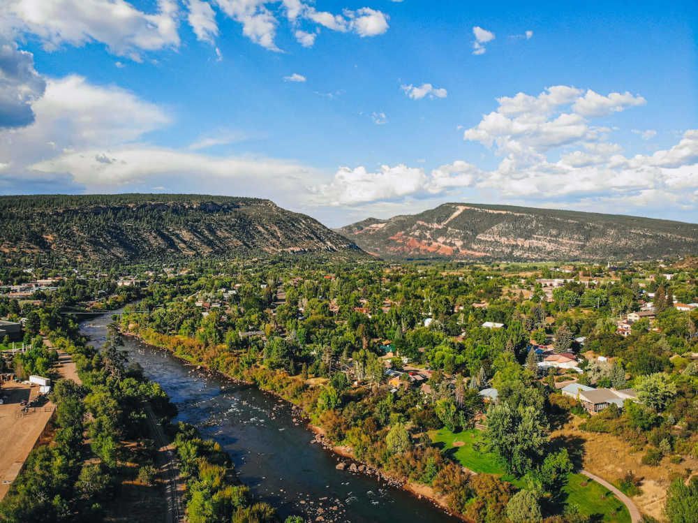 Photo of Durango, CO and the Lower Animas river running through town from above.