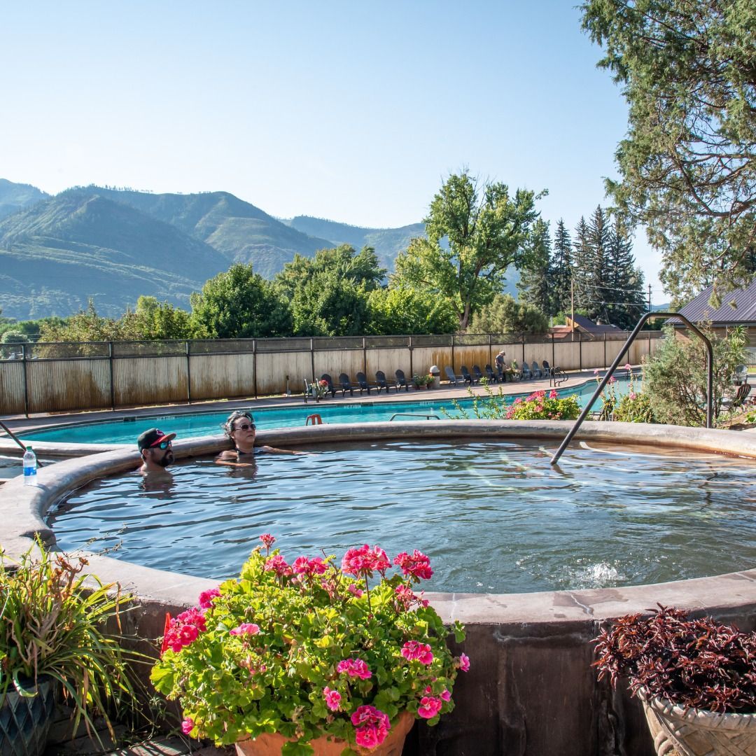 Two people relaxing in a hot spring at Durango Hot Springs Resort.