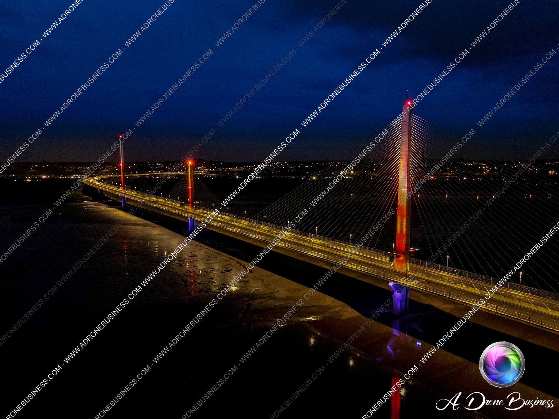 Mersey Gateway Bridge lit up at night in support of various charities dusing Covid 2020, Widnes, Runcorn, Halton, Liverpool, Cheshire, Merseyside, United Kingdom