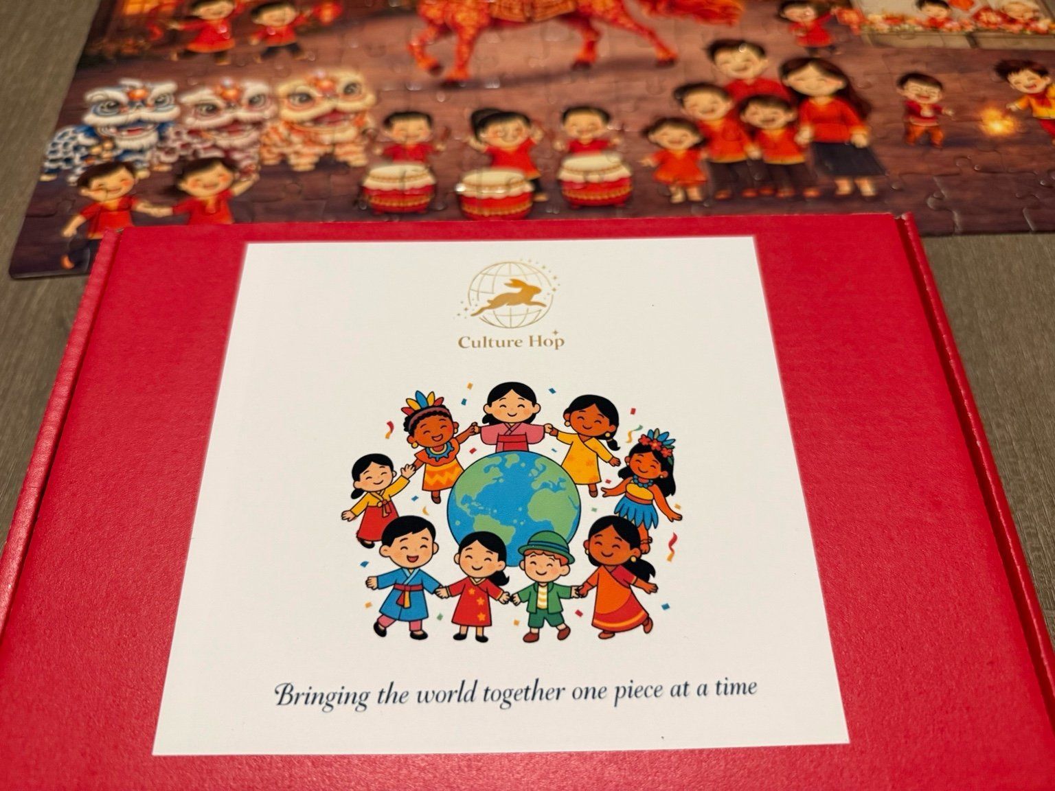 children from different cultures holding hands around a globe, with Culture hop logo of a bunny hopping on a globe, red box