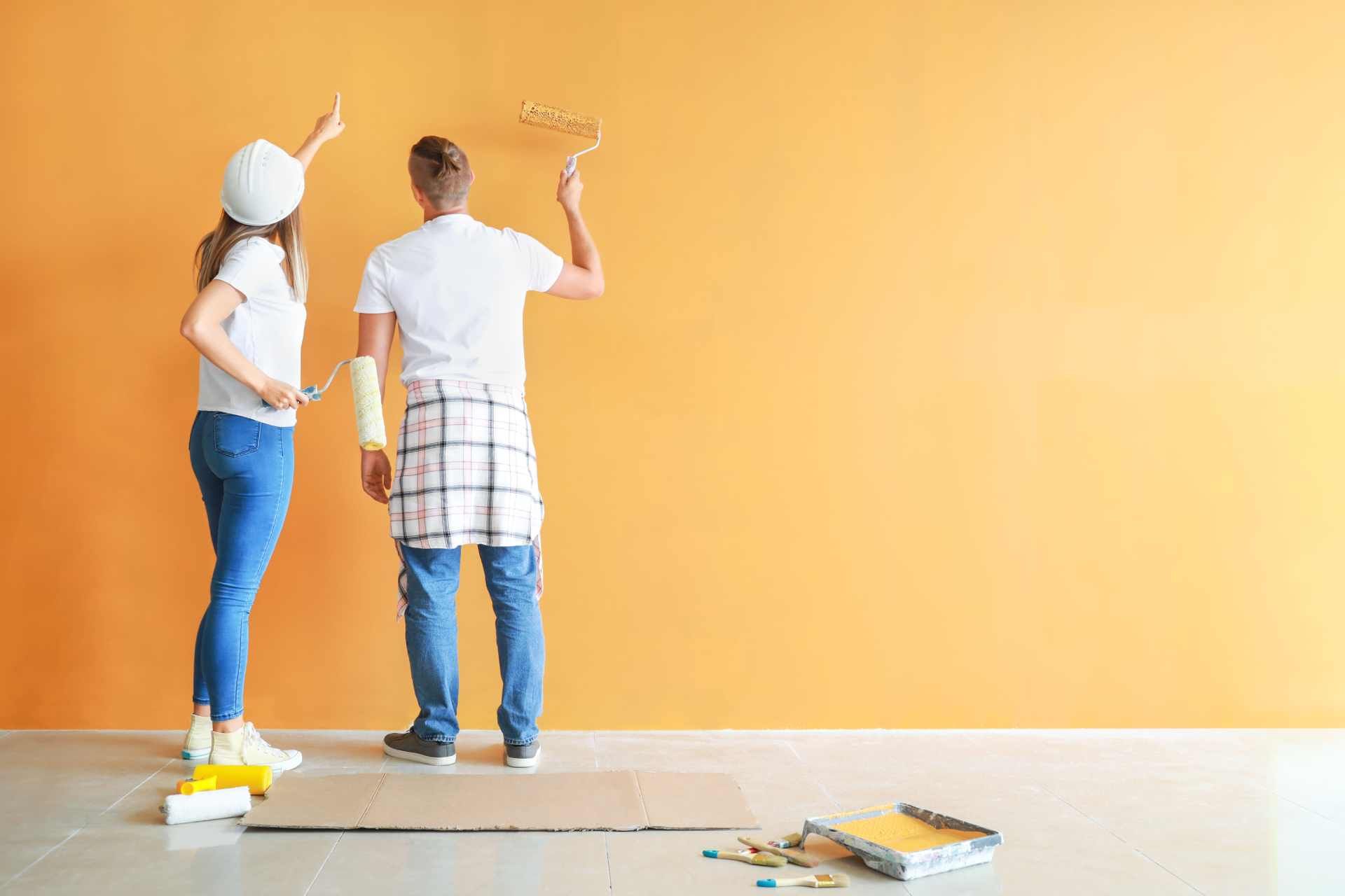 2 people painting their home with bright Benjamin Moore paint near Corning, New York (NY)