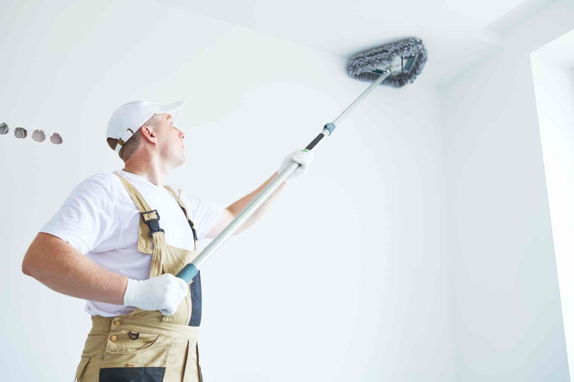 Painter using essential paint tools to prep before applying paint to the walls and ceiling  at Steve