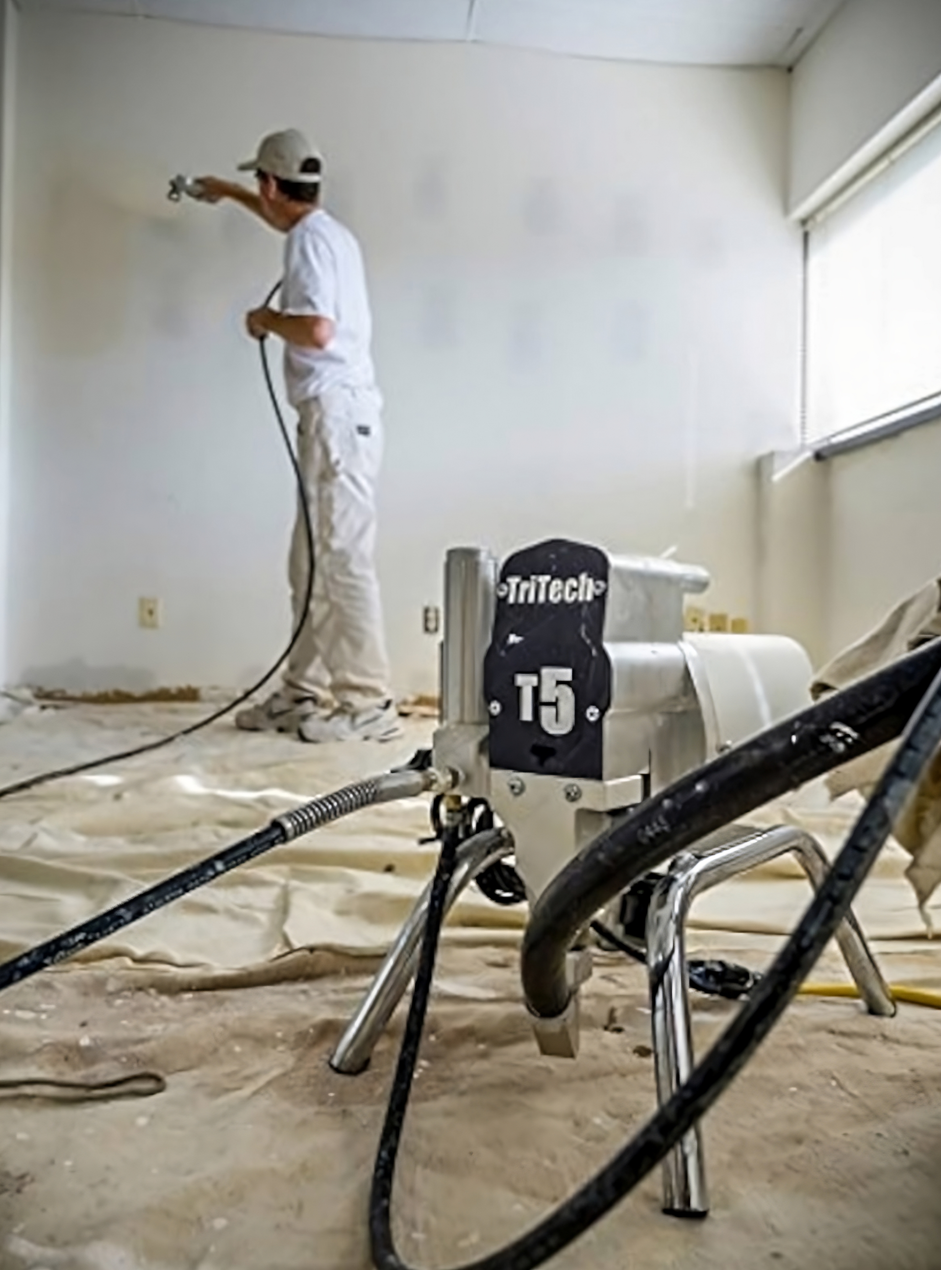 A painter working with a TriTech paint sprayer at Stevens Paint & Blinds near Vestal and Corning, New York (NY)