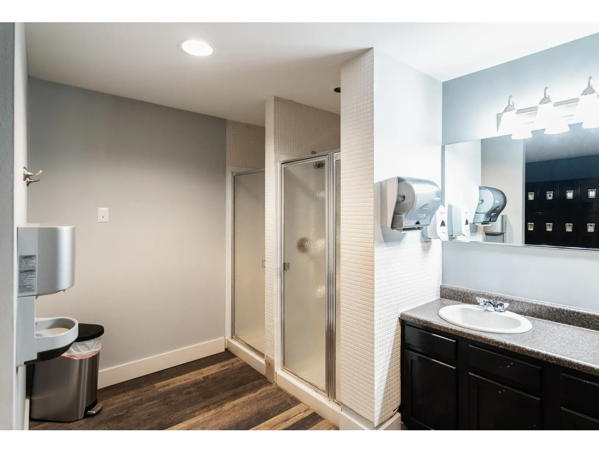 Clean and modern bathroom facility with shower and sinks
