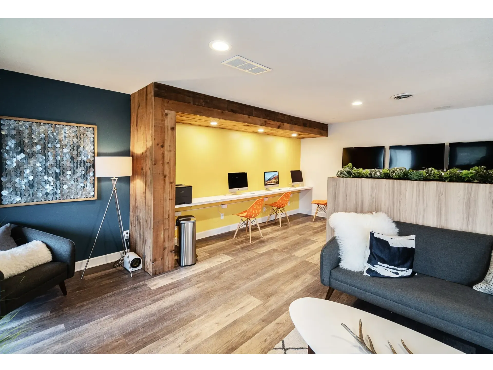 Modern shared workspace with computers and comfortable seating