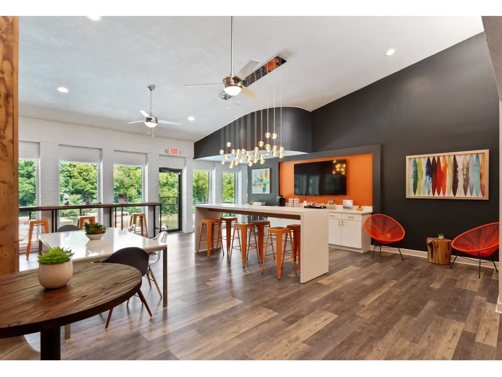 Modern community lounge area with seating and large windows.