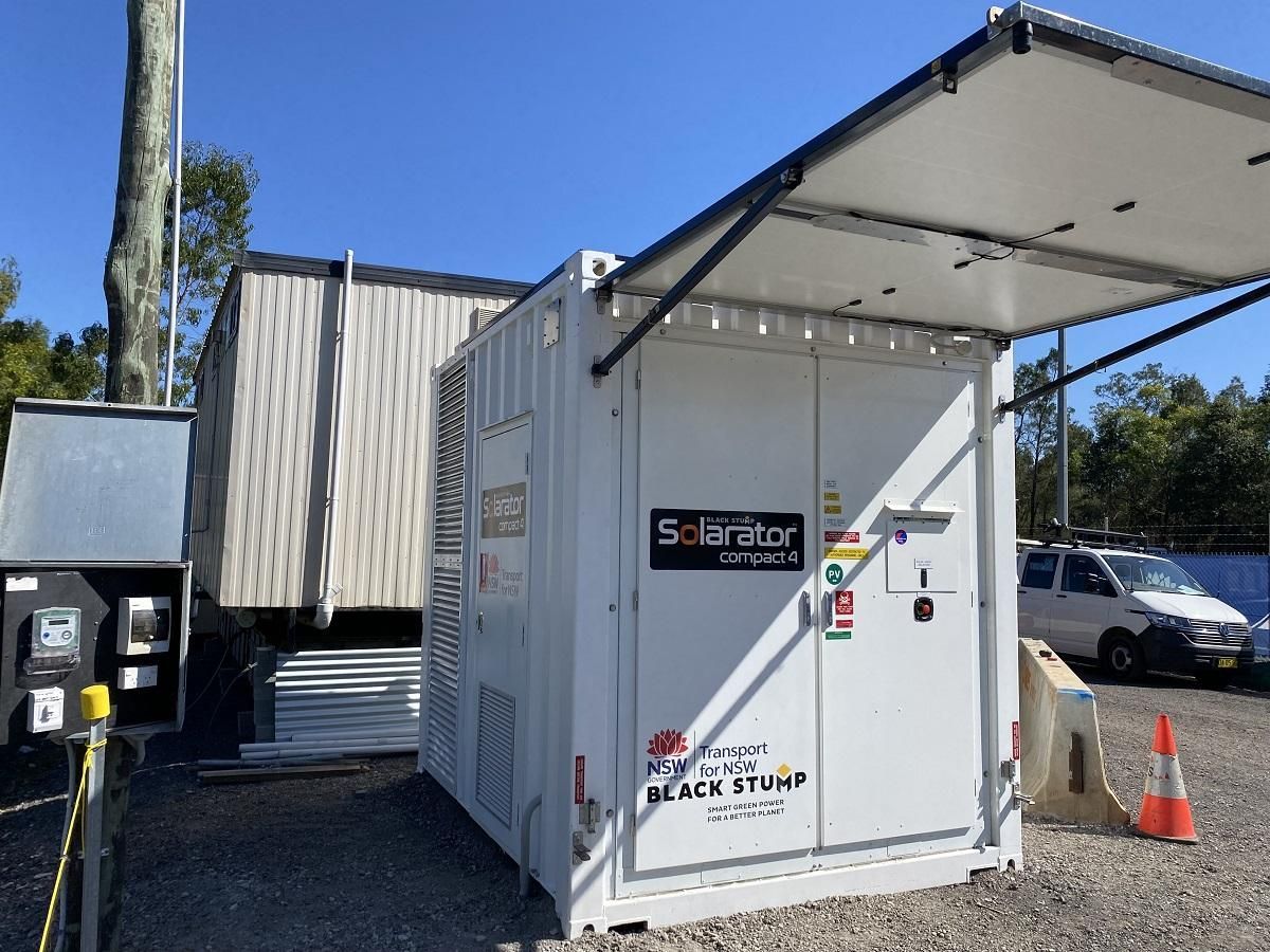 SolarStar generator unit with open top panel at a construction site.
