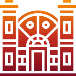 Red and orange building with symmetrical columns and a rounded window above a doorway.