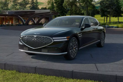 Dark gray Genesis sedan with a large grill and unique wheels.