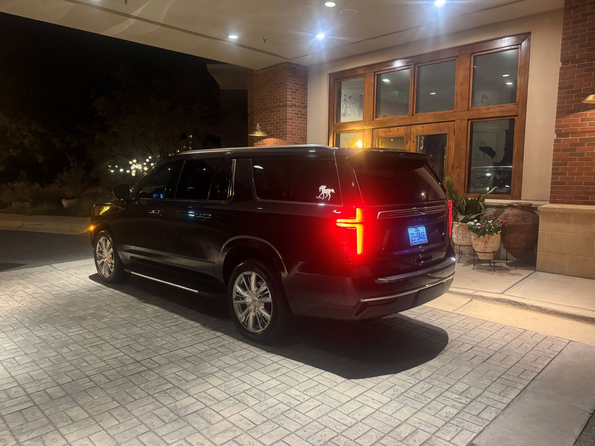 Man in a suit reviewing papers while seated in a car.