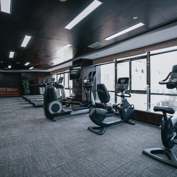 A man and two women are standing next to each other holding cleaning supplies.