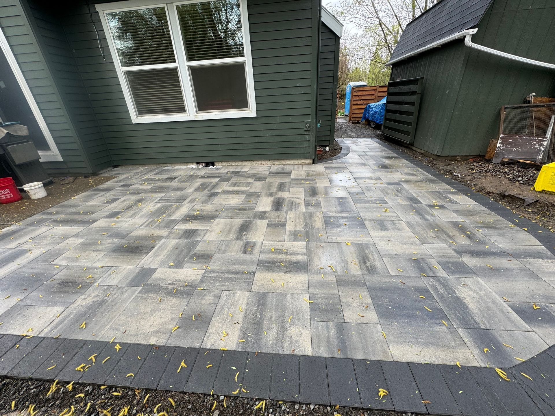 A patio is being built in front of a house.
