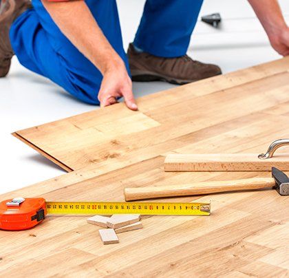 Floor Refinishing — Man Installing Wood Flooring in Cortland, OH