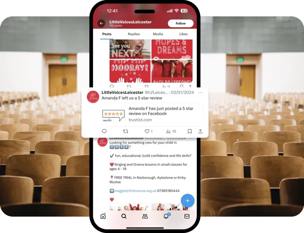A cell phone is sitting in front of a row of chairs.