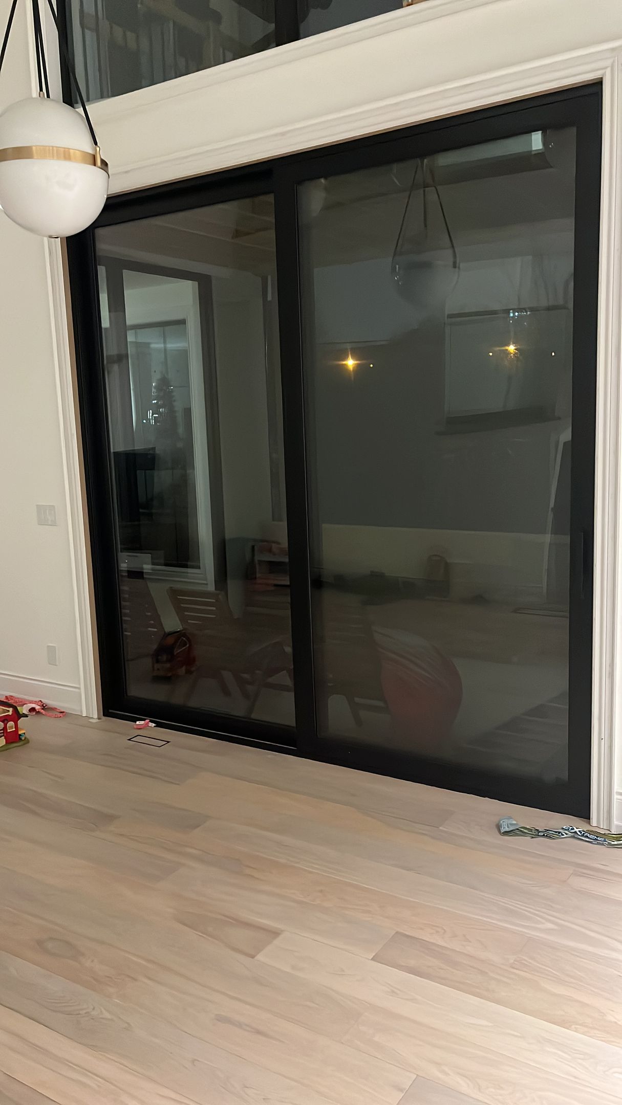 There is a sliding glass door in the middle of the room.
