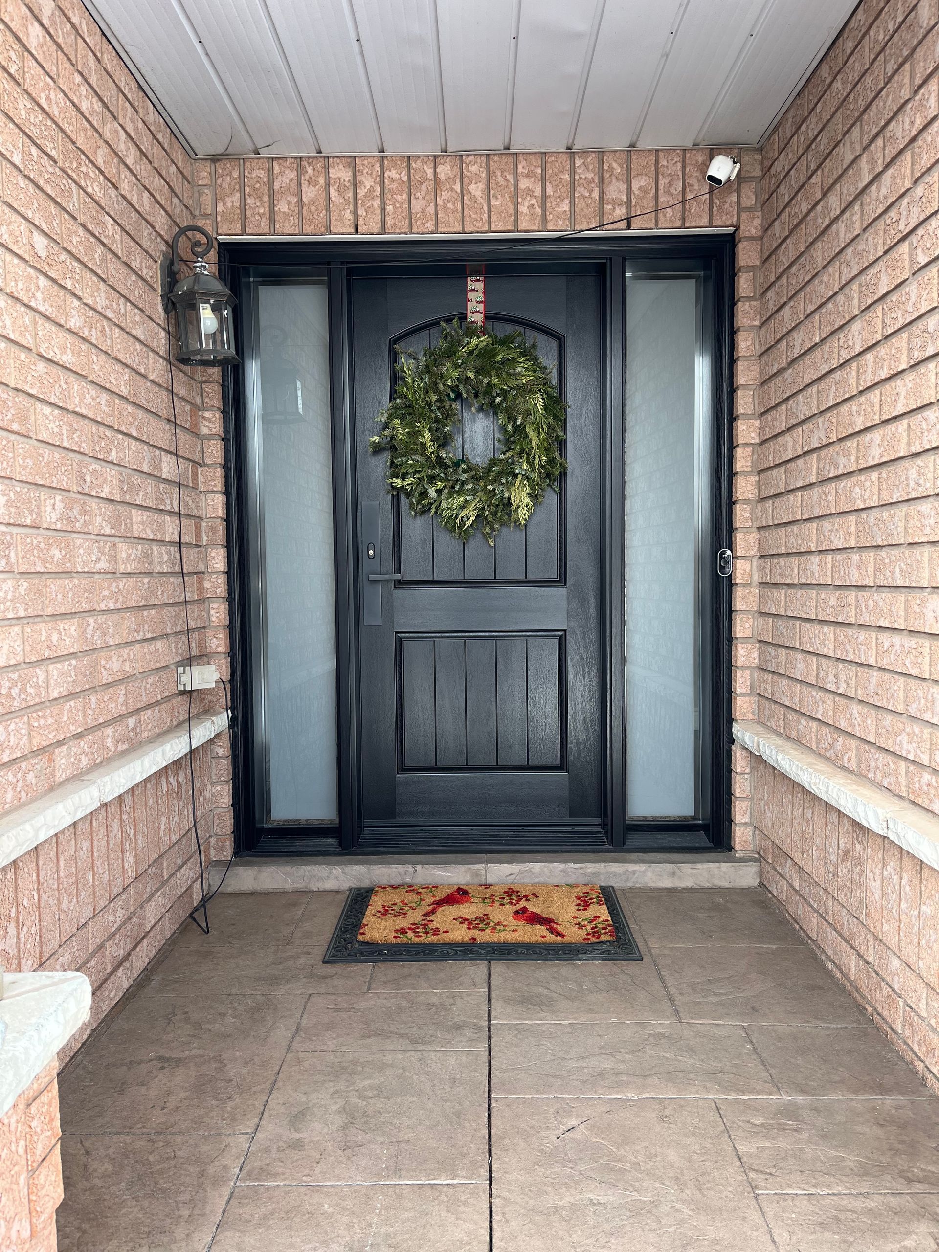 The front door of a house with a wreath on it.