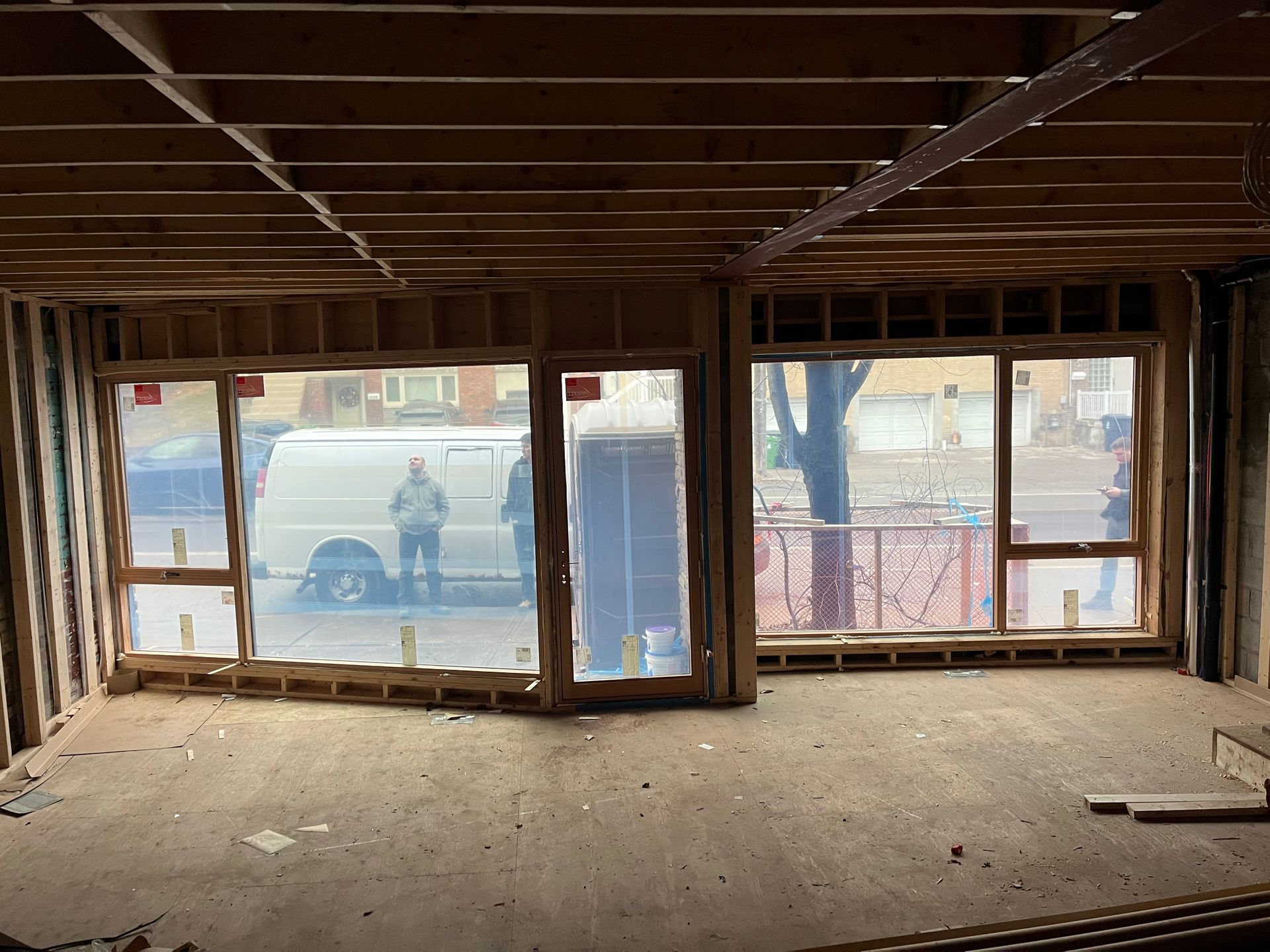 A room with a lot of windows and a van in the background