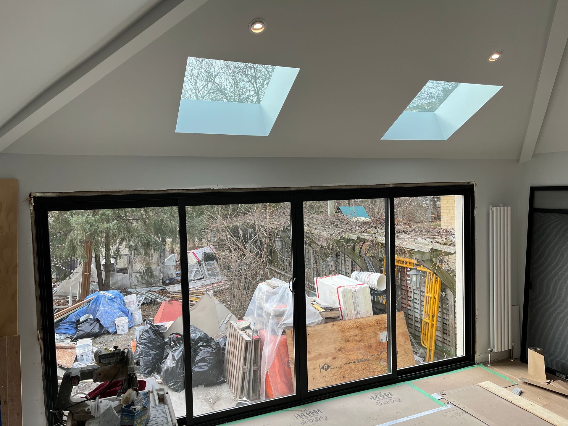 A room with a lot of windows and skylights on the ceiling.