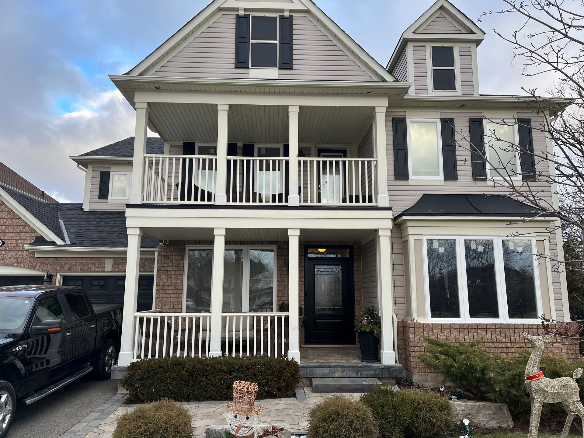 A large house with a car parked in front of it.