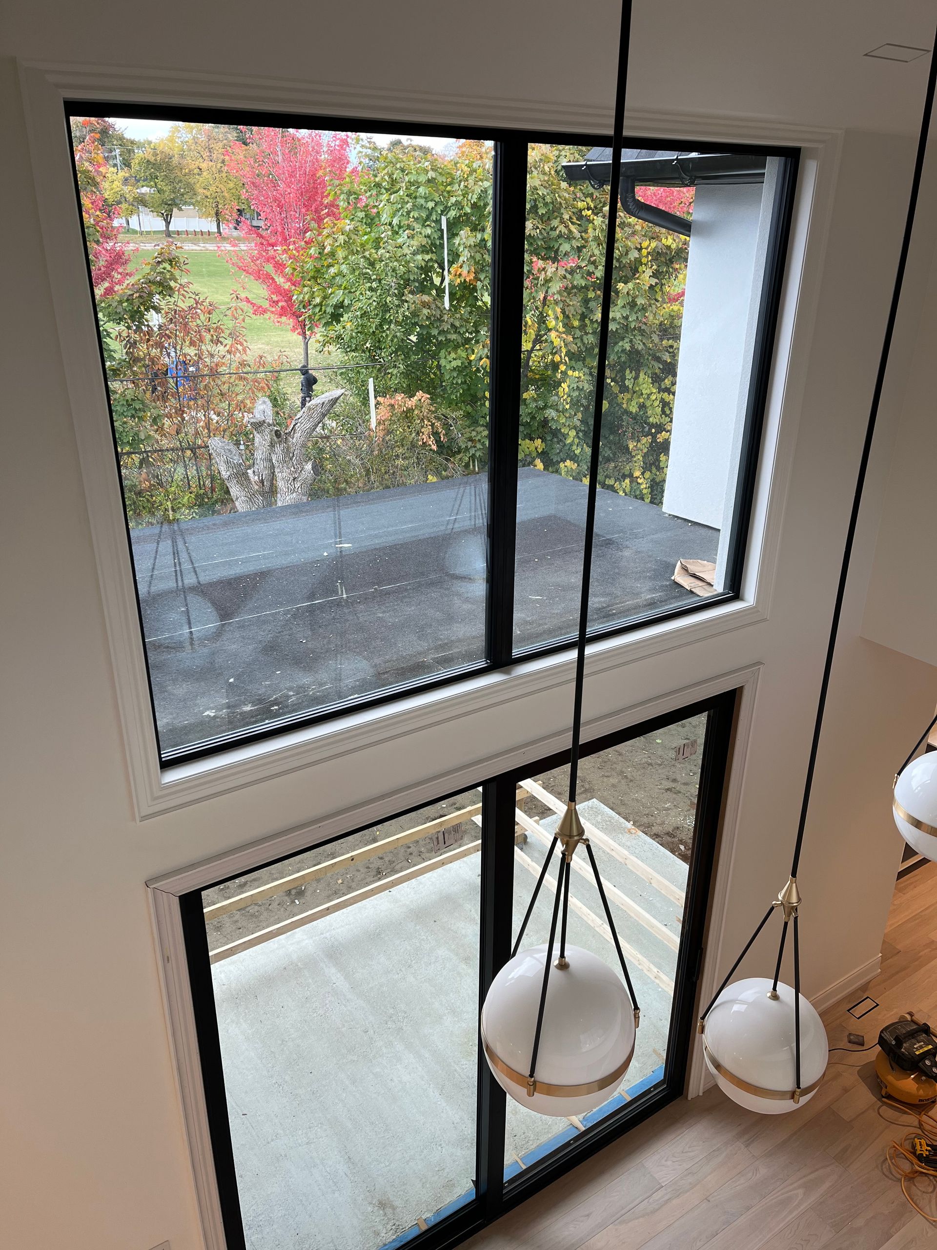 An aerial view of a house with a large window and sliding glass doors.