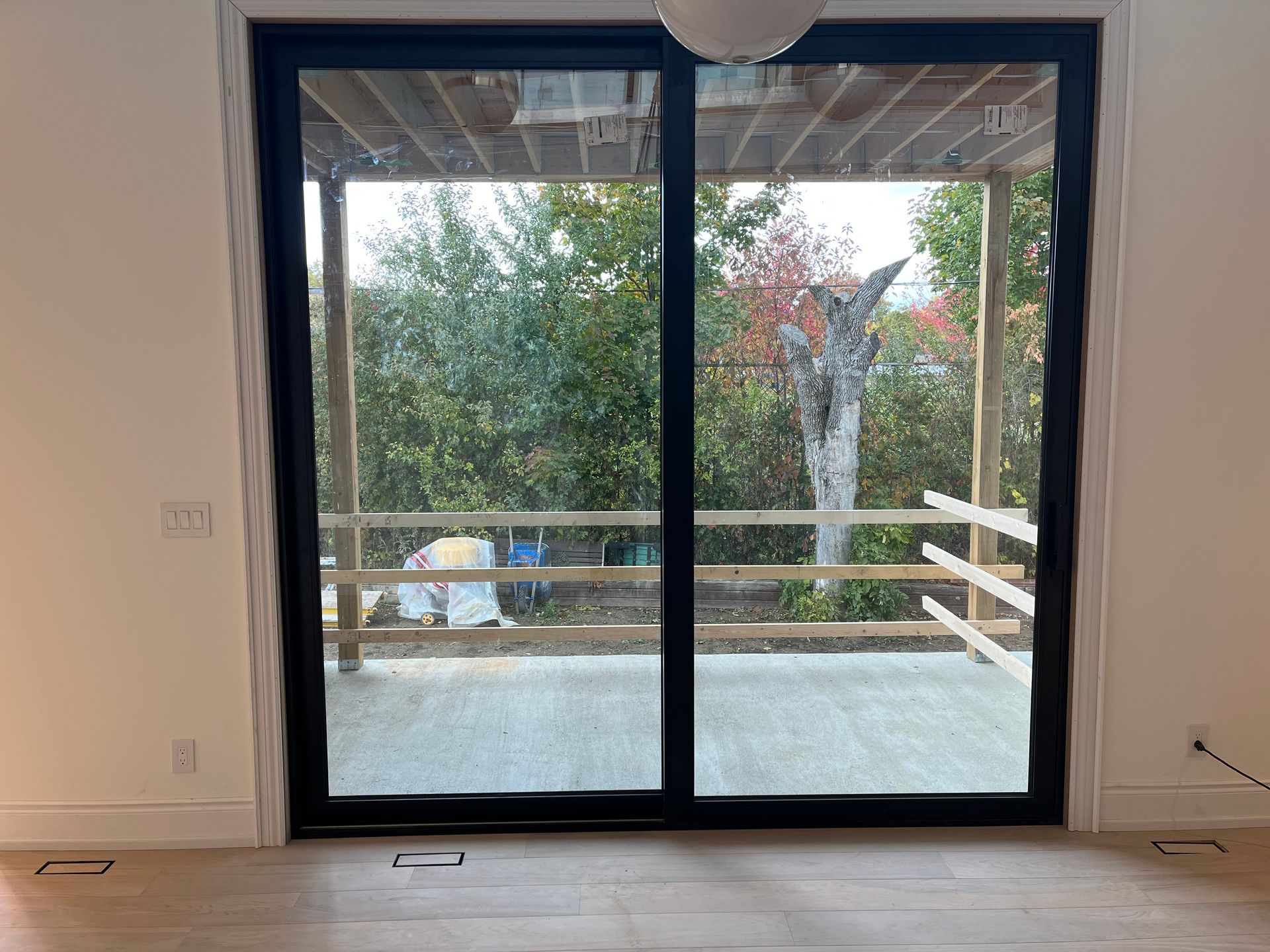 A room with a sliding glass door leading to a deck.