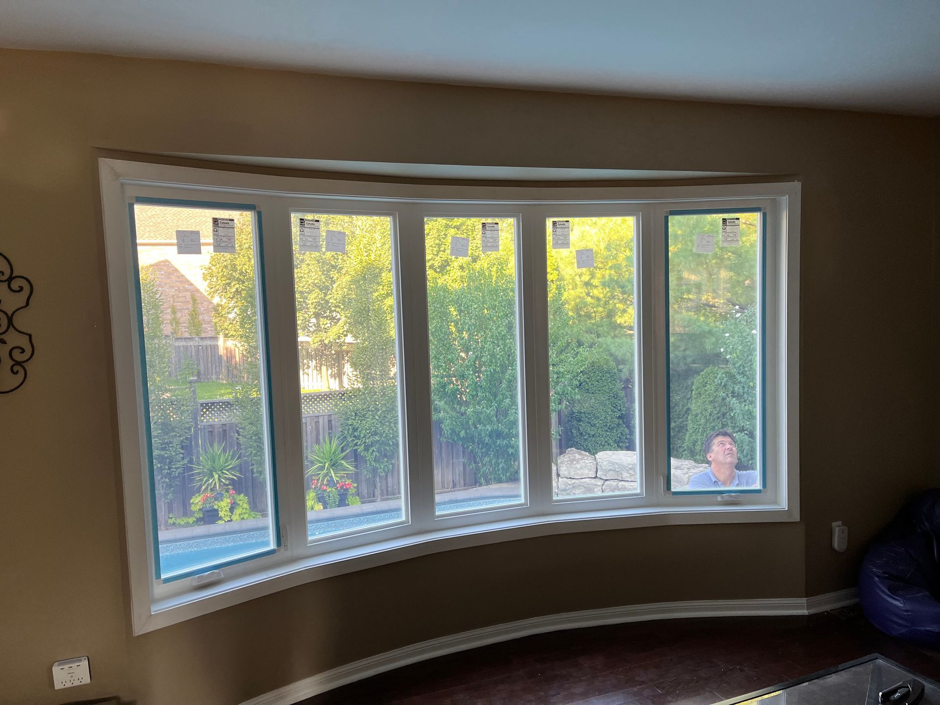 A living room with a large bay window and a couch.