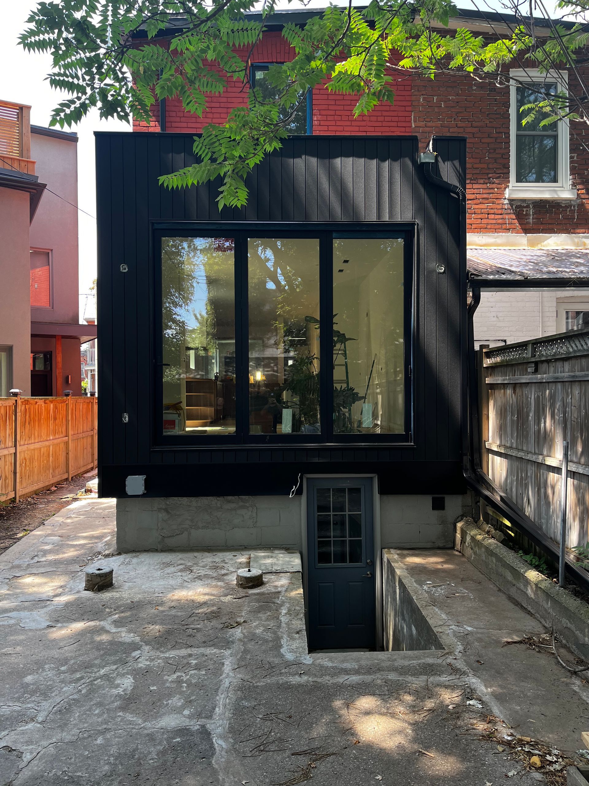 The back of a house with a window and a door