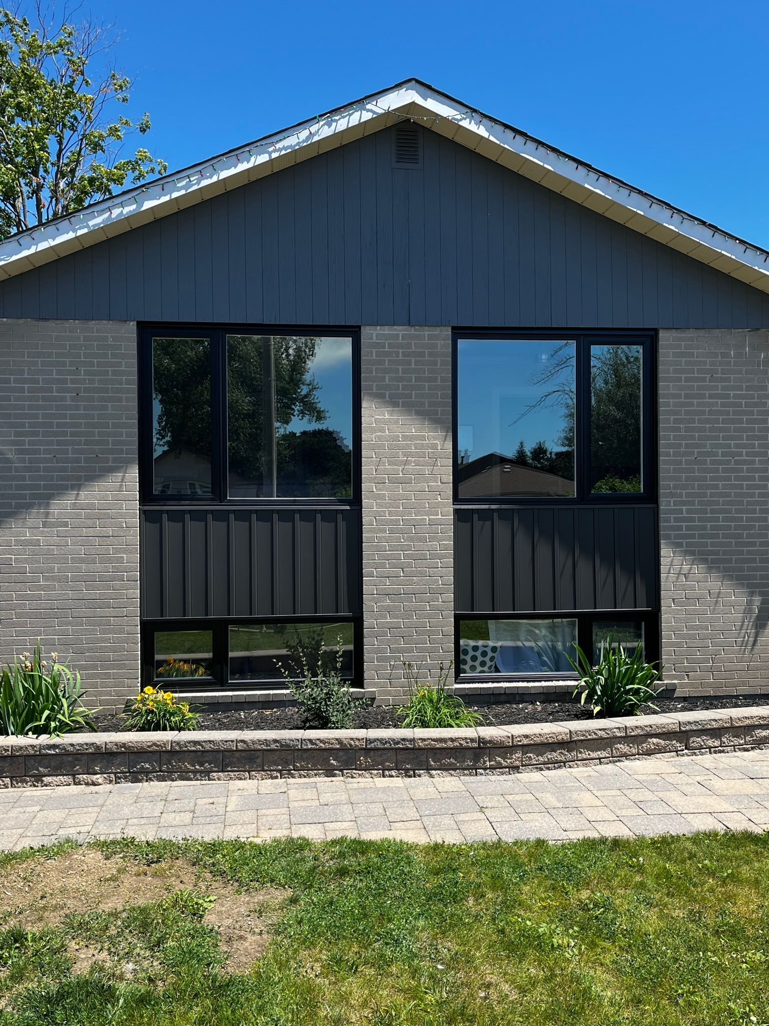 A house with a lot of windows and a blue sky in the background.
