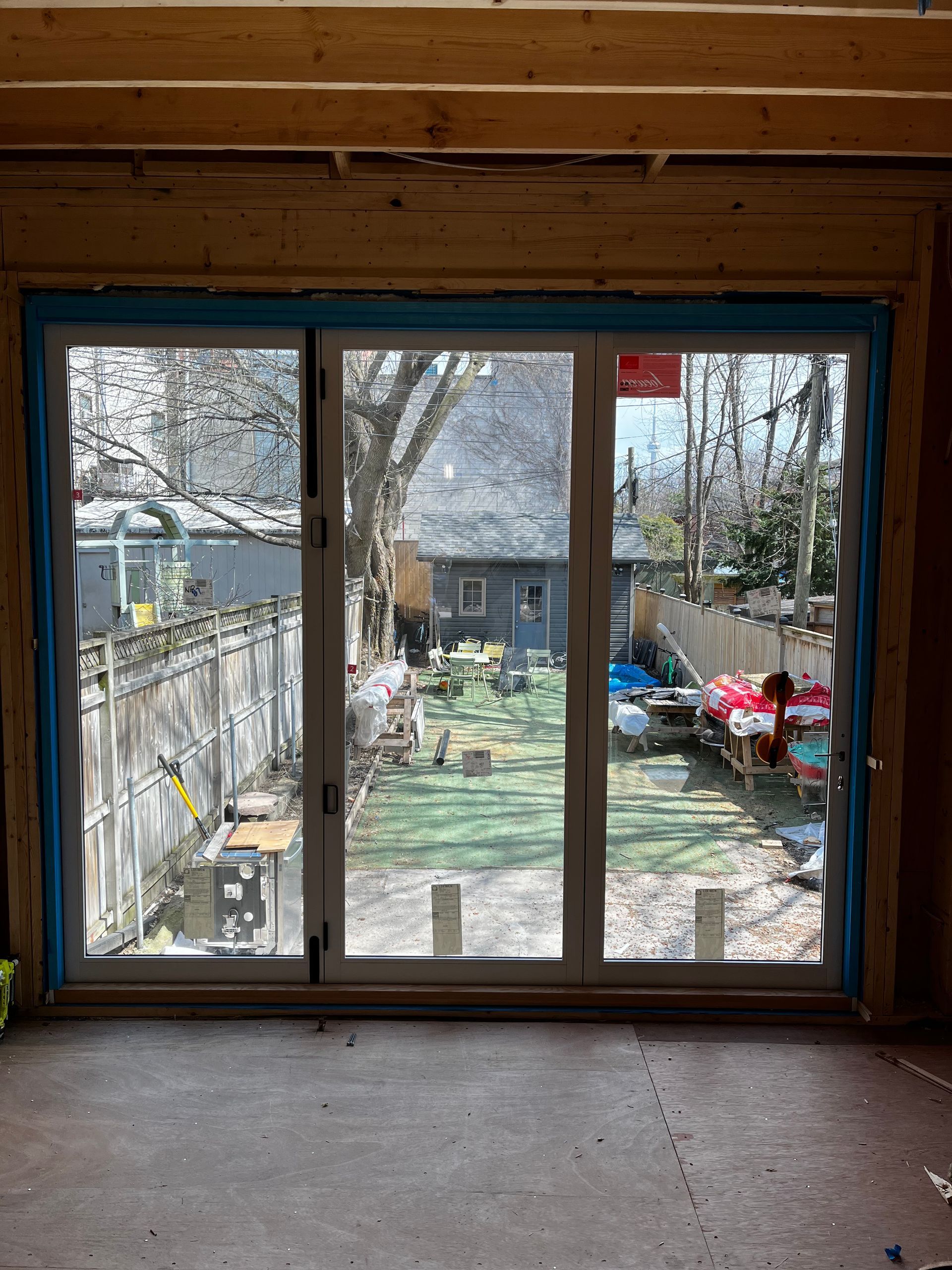 A room with a sliding glass door and a view of a backyard.