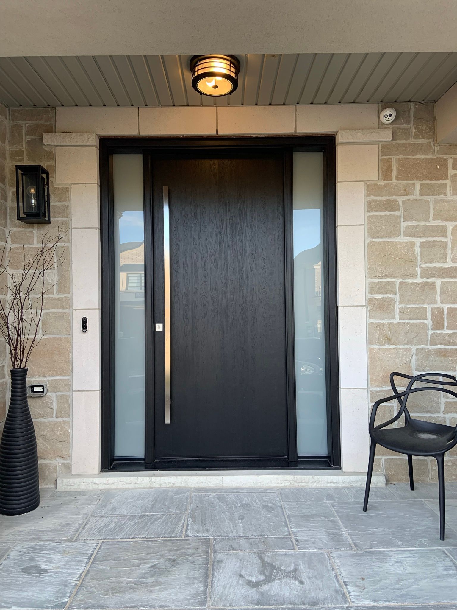The front door of a house with a chair in front of it.