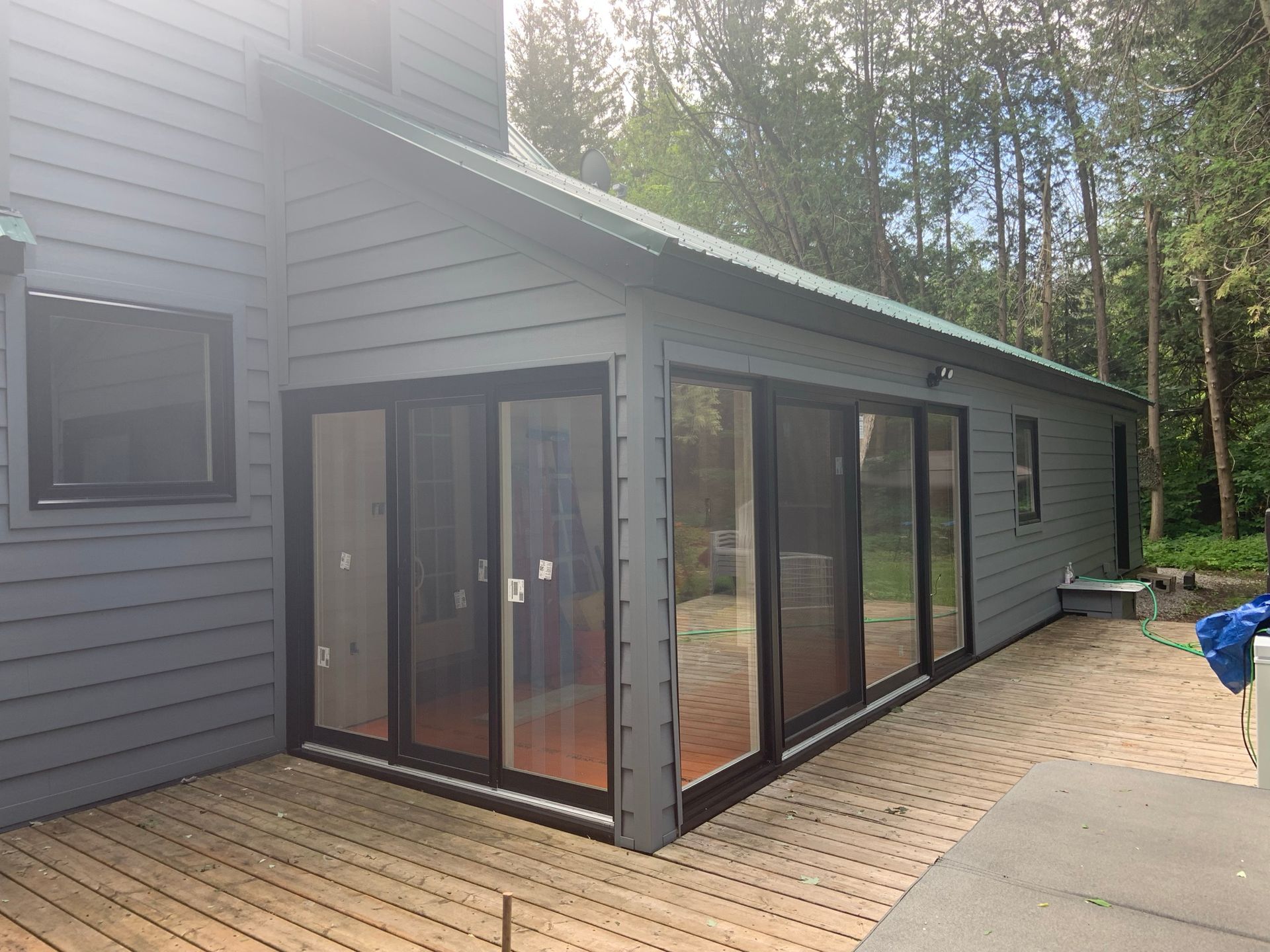 A house with a lot of windows and sliding glass doors