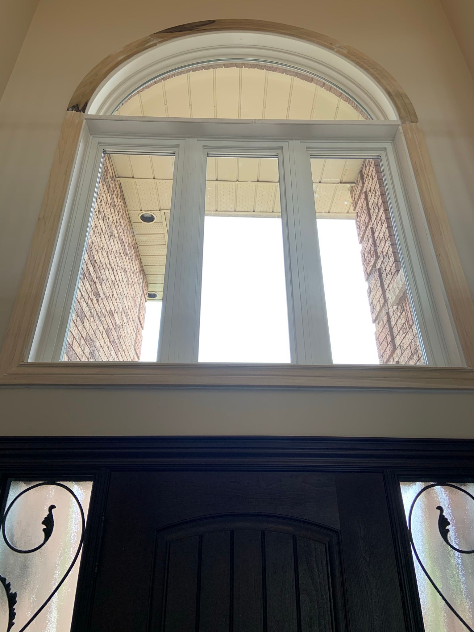 Looking up at a window over a door in a house