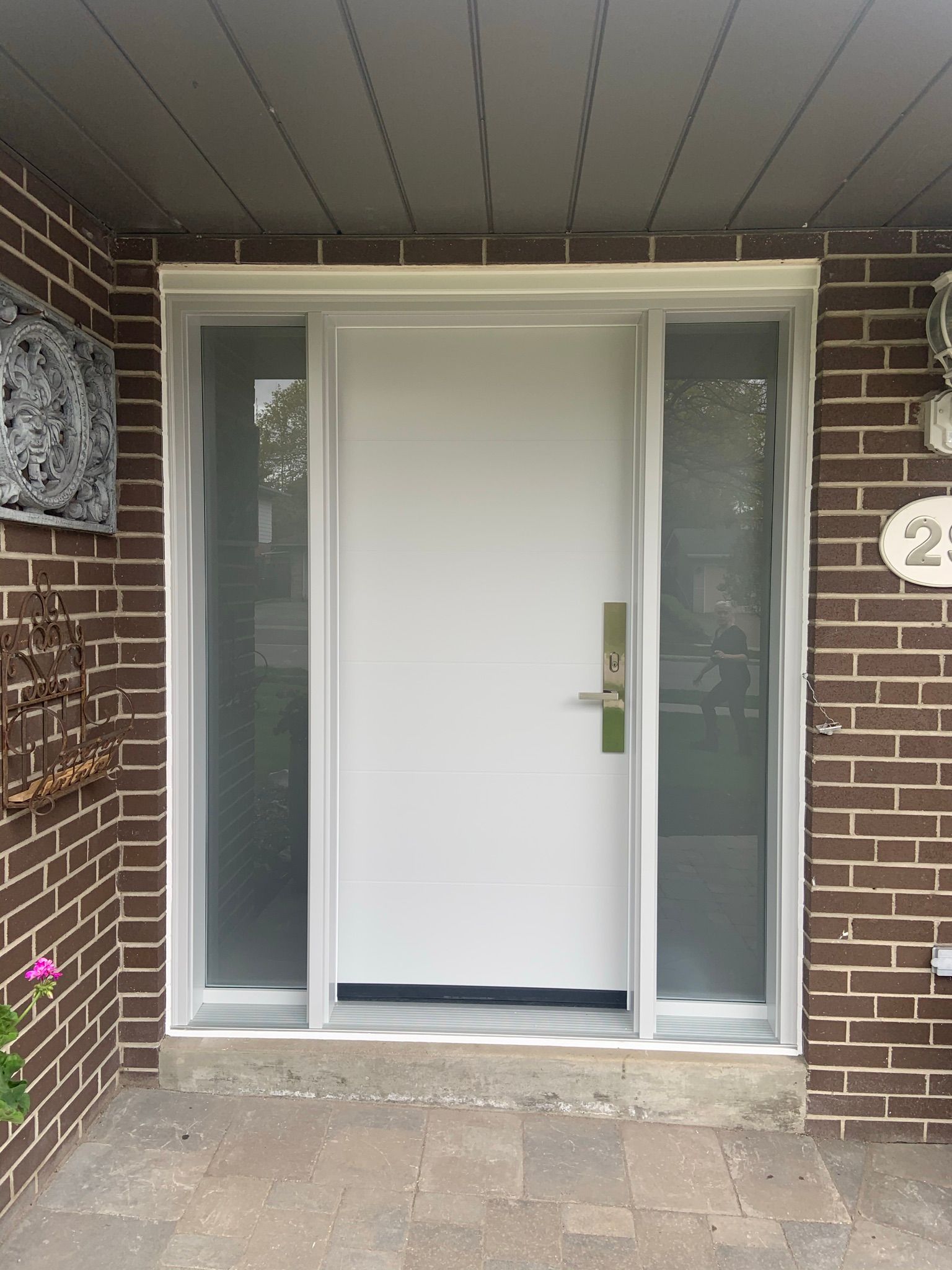 The front door of a brick house with a white door