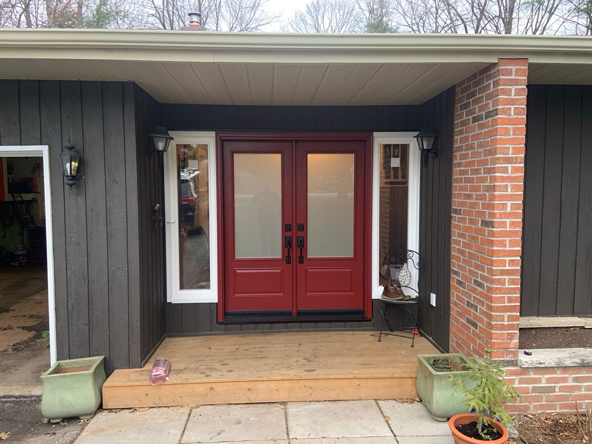 A house with a red door and a brick wall