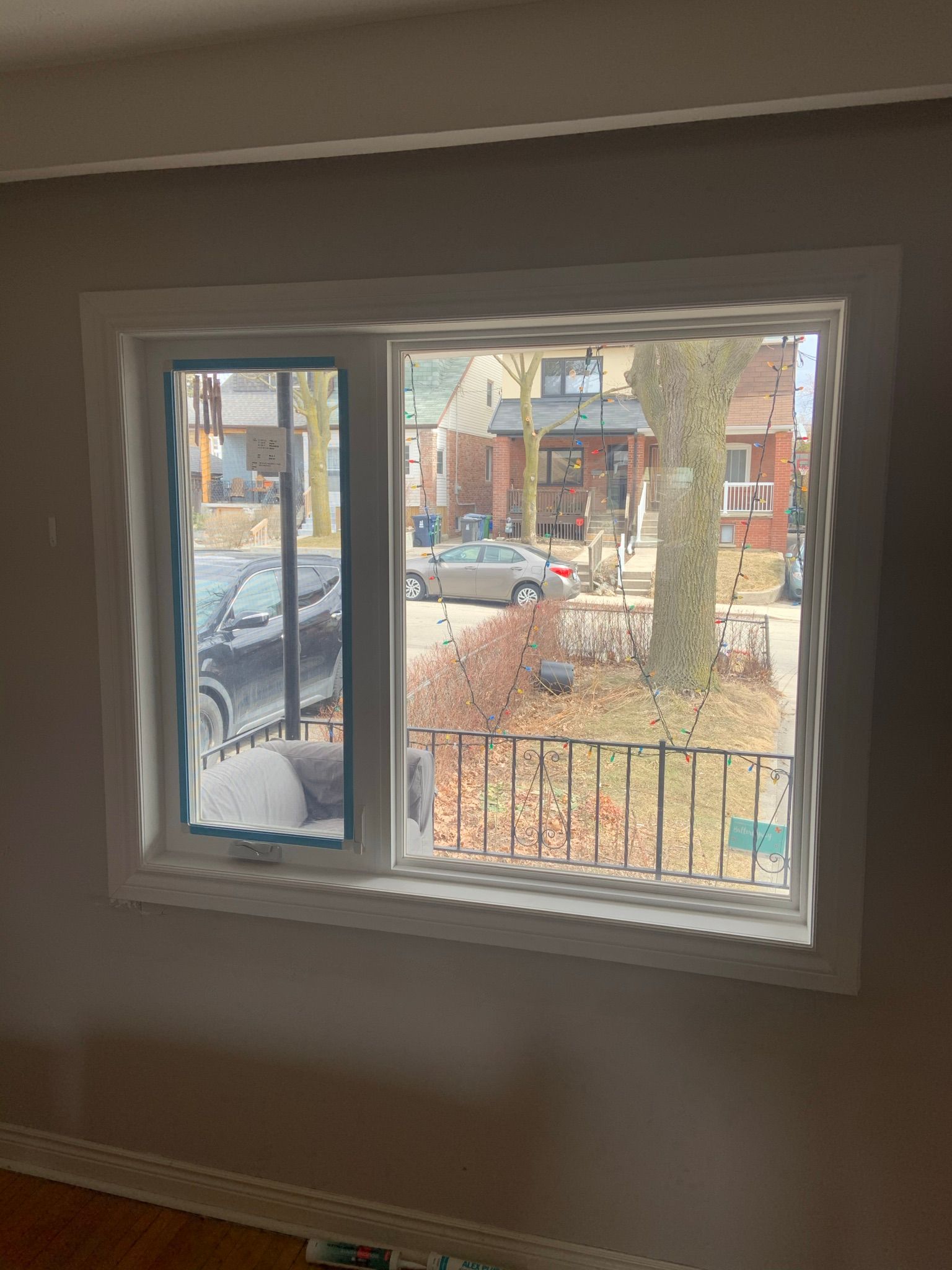 A large window in a room with a view of a street.