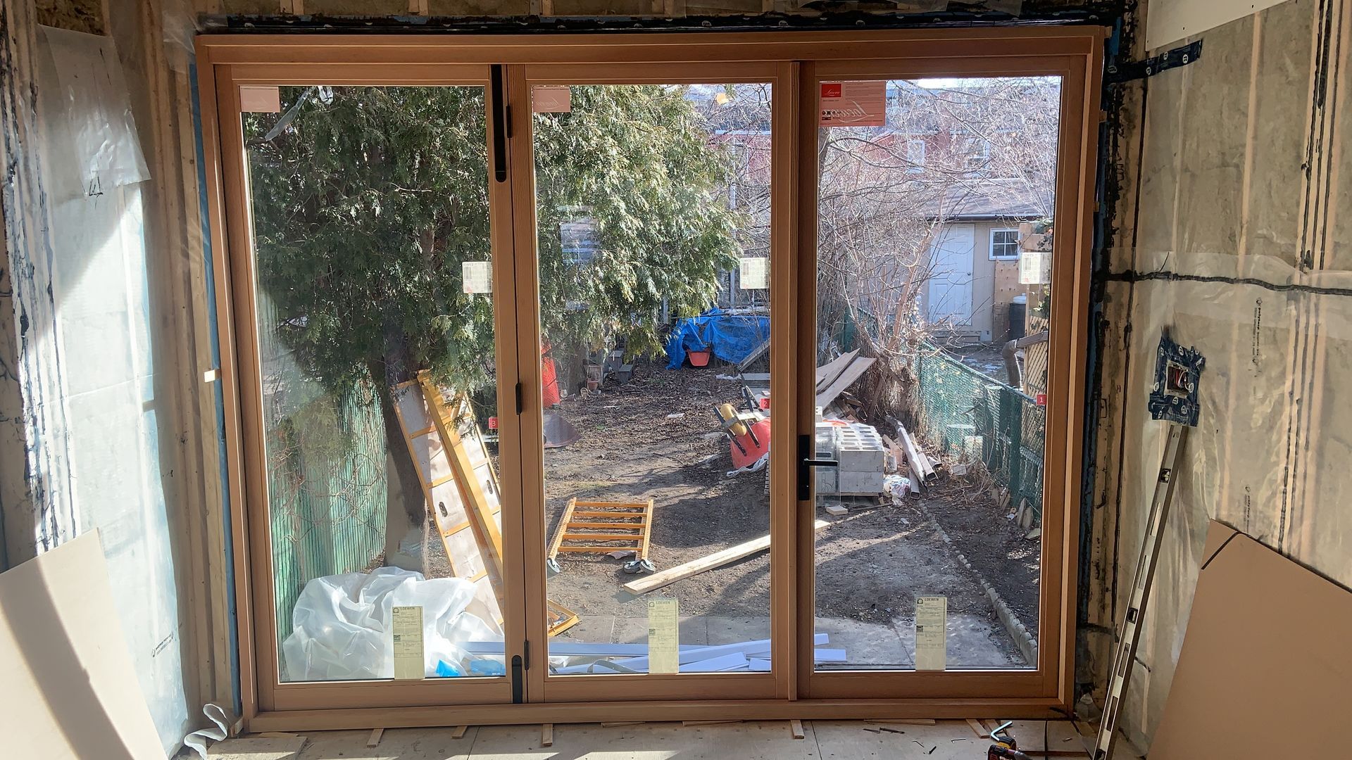A large window in a room with a view of a construction site.