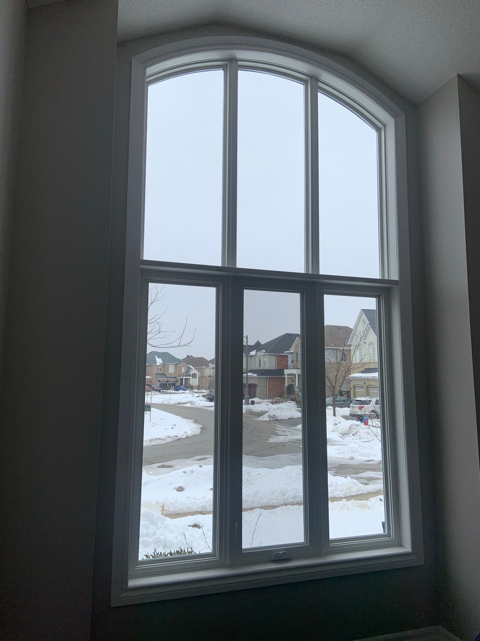 A large window with a view of a snowy street