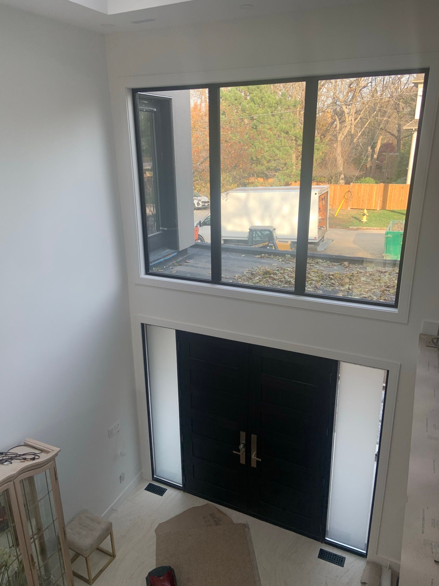A living room with a fireplace and a large window.