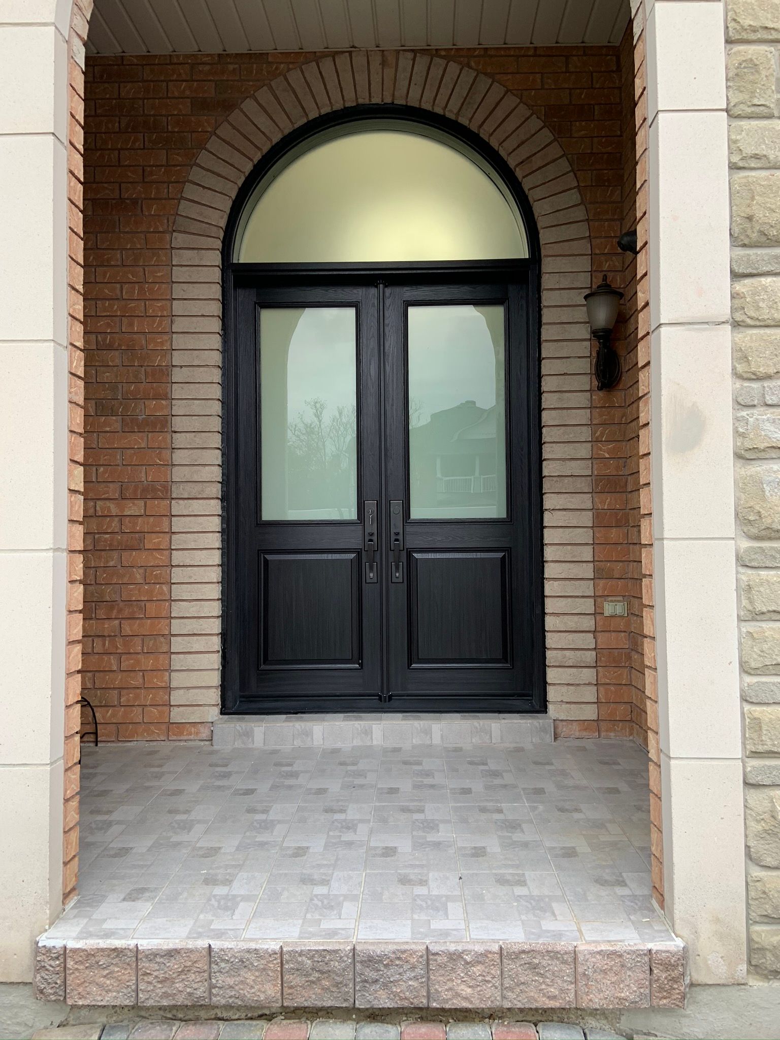 The front door of a brick building with a black door