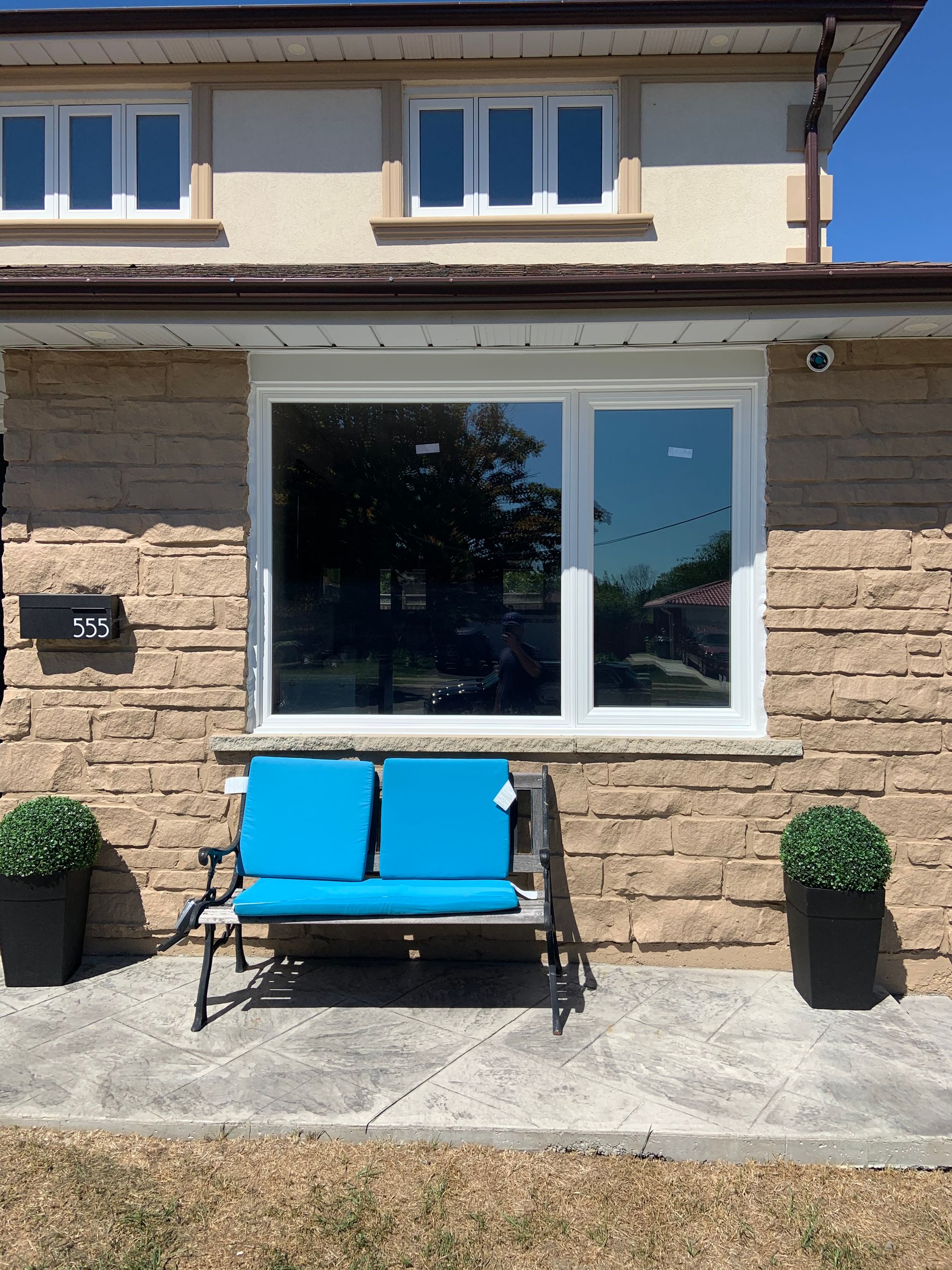 A house with a blue bench in front of it
