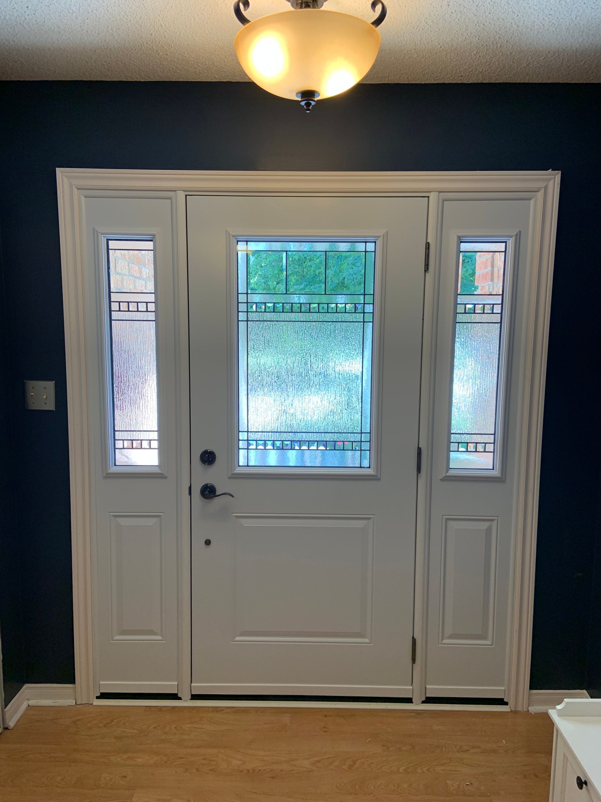 A white door with a stained glass window
