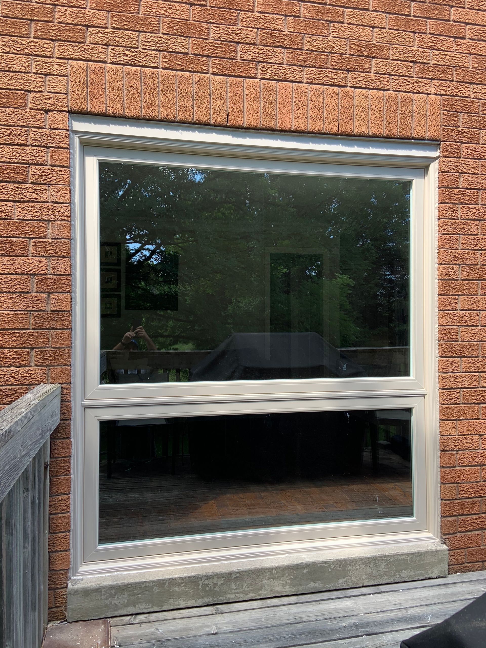 A large window on the side of a brick building.