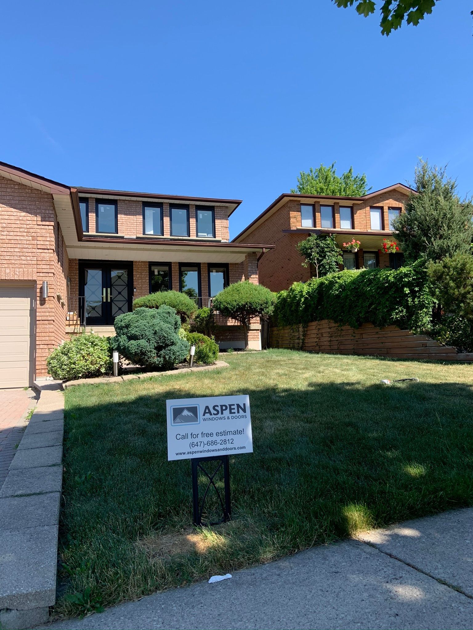 A house with a sign in front of it that says aspen