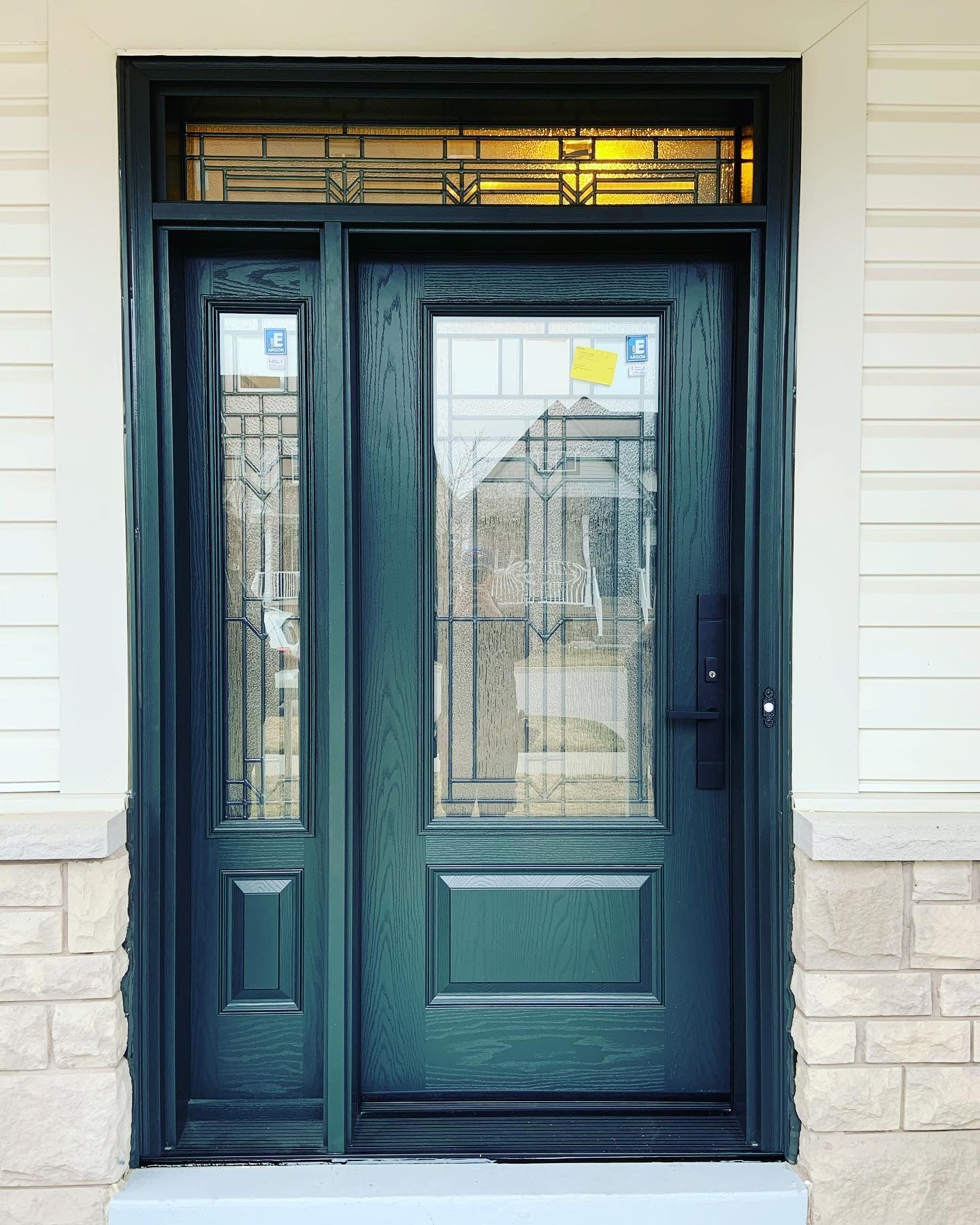 A green front door with a stained glass window