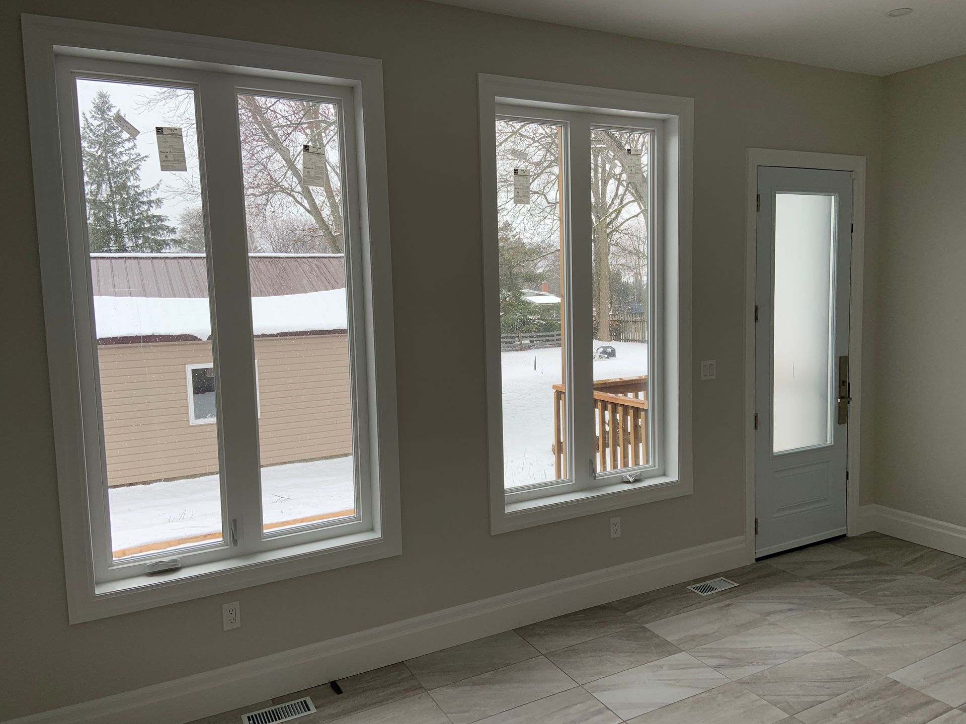 A room with a lot of windows and a door.