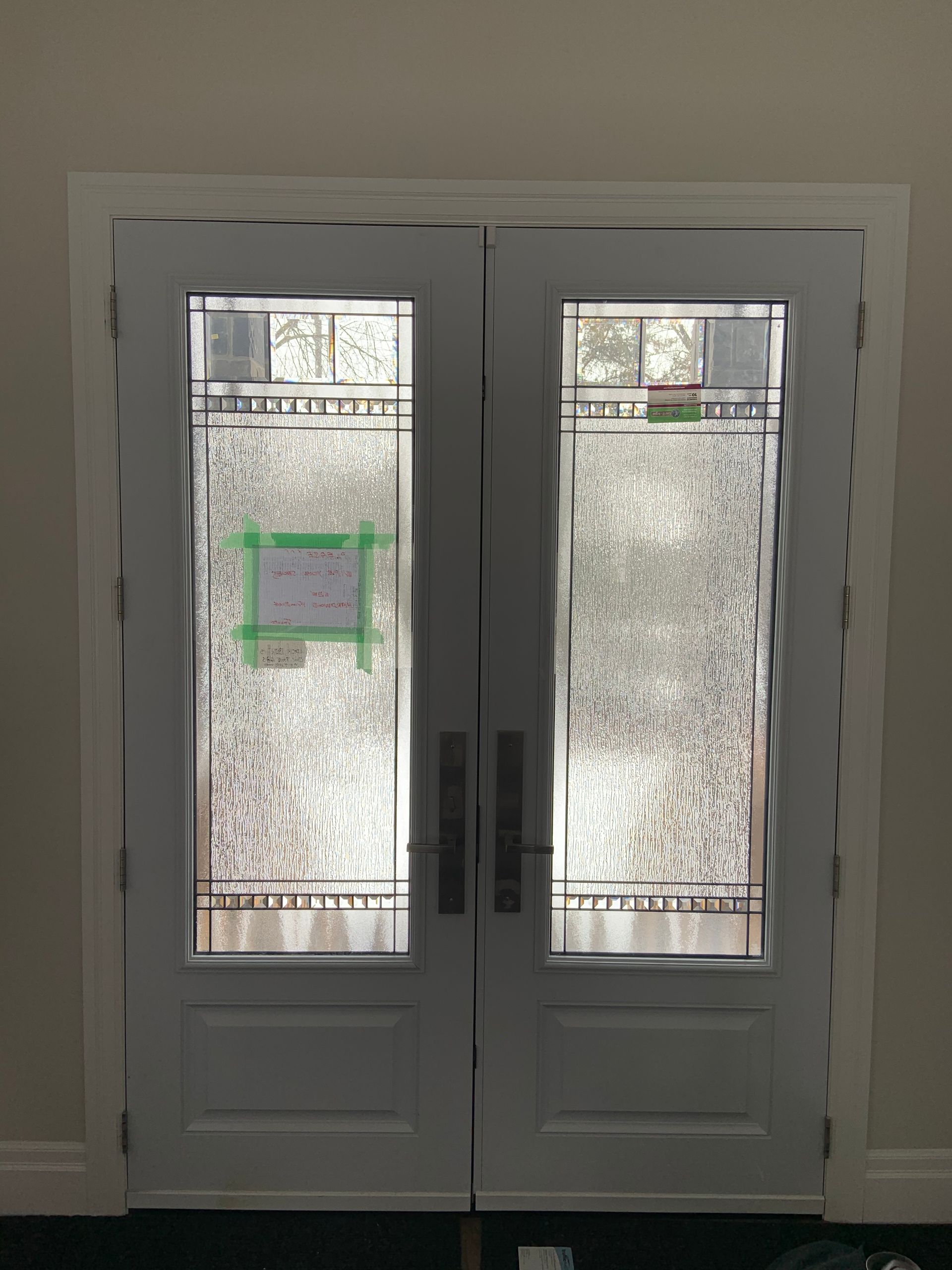 A pair of white doors with stained glass windows