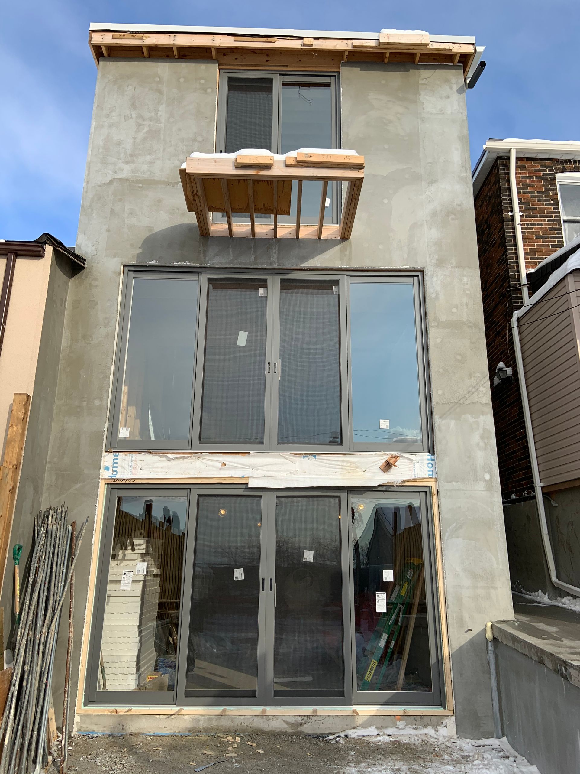 A building under construction with a lot of windows and doors.